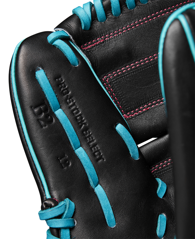 Close-up of the Wilson A2K B2 12" Baseball Glove, crafted from Pro Stock Select leather with bright blue laces, red stitching, a Closed 2-Piece Web, and inner palm markings including "PRO STOCK SELECT." Model: WBW10269212.