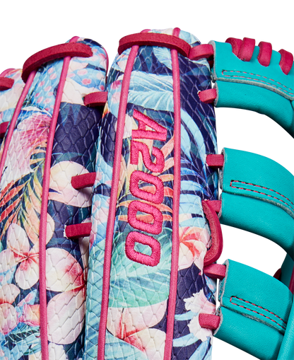 Close-up of the Wilson A2000 RA56 12.75" Randy Arozarena GM Baseball Glove, featuring a tropical floral pattern, teal blue lacing, SuperSnakeSkin accents, pink stitching, and bold pink A2000 embroidery. SPRING 2025 release.