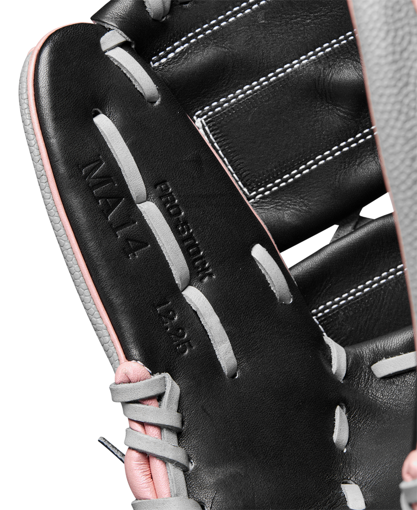 Close-up of the Wilson A2000 MA14SS 12.25" Fastpitch Glove by Wilson, featuring black Pro Stock leather, gray and pink laces, visible stitching, and embossed with MAYA, PRO-SOFT, and 12.25—Monica Abbott glove inspired.