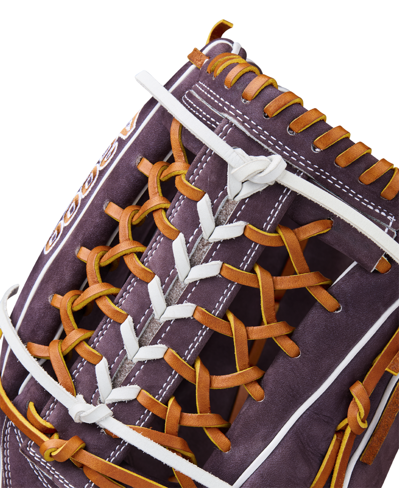 Close-up of the Wilson A2000 T125 12.5" Aliyah Andrews GM Fastpitch Glove (WBW102745125), showcasing dark brown leather with orange and white laces, detailed stitching, and craftsmanship inspired by Aliyah Andrews.