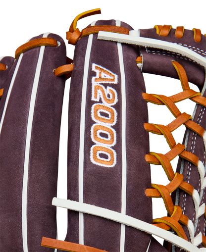 Close-up of a Wilson A2000 T125 12.5" Aliyah Andrews GM Fastpitch Glove (WBW102745125), a brown leather outfield glove with orange and white laces, featuring the embroidered A2000 logo, inspired by Aliyah Andrews.