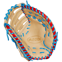 The Wilson A2000 1677 12.5" First Base Mitt (Spring 2025, WBW102753125) features tan Pro Stock leather, blue and red laces, detailed stitching, an open web, and the A2000 logo in the palm.