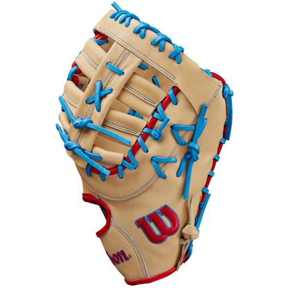 The Wilson A2000 1677 12.5" First Base Mitt (SPRING 2025: WBW102753125) by Wilson features tan Pro Stock leather, blue laces, red accents, and a red and blue logo on the thumb, displayed on a plain white background.
