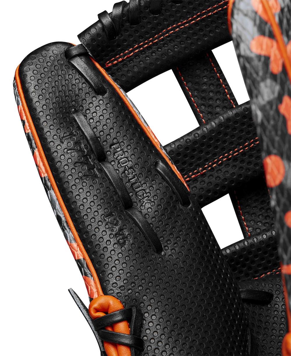 Close-up of the Wilson A2000 SC1777SS 12.75" Baseball Glove (GOTM October 2024, WBW1027911275) in black with orange stitching and perforated Pro Stock leather. Features detailed leather, webbing, and embossed Wilson branding.