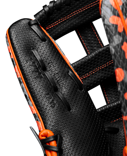 Close-up of the Wilson A2000 SC1777SS 12.75" Baseball Glove (GOTM October 2024, WBW1027911275) in black with orange stitching and perforated Pro Stock leather. Features detailed leather, webbing, and embossed Wilson branding.
