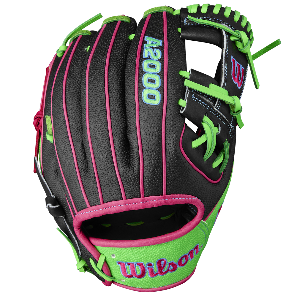 The Wilson A2000 1786SS 11.5" Baseball Glove (WBW103218115) features a black design with green laces and stitching, pink trim, blue logos, and durable SuperSkin on the wrist strap and back.