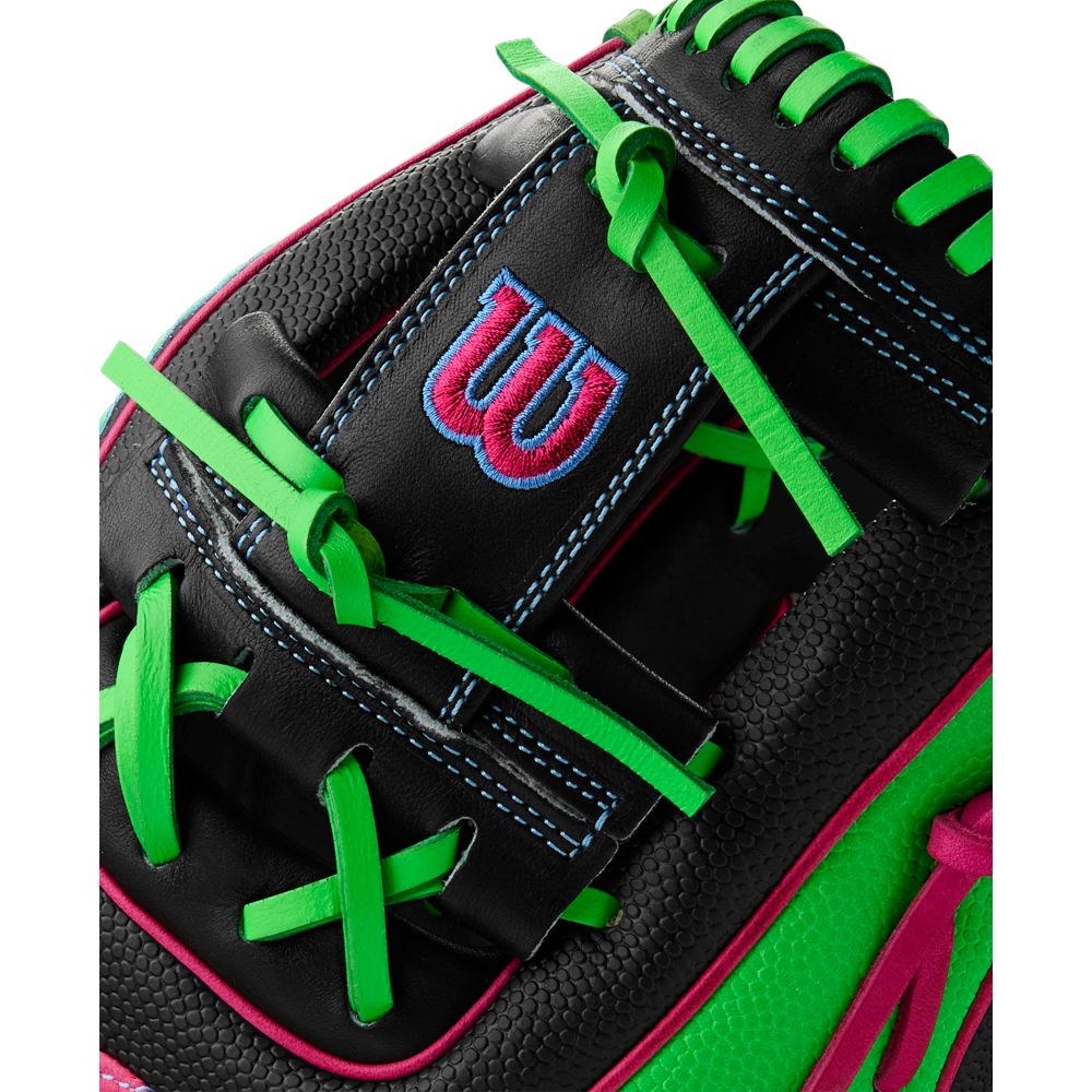 Close-up of the Wilson A2000 1786SS 11.5" Baseball Glove (WBW103218115), made with black leather, durable SuperSkin, bright green laces, blue stitching, a red and blue "W" logo, and pink edge accents. Summer 2025 model.