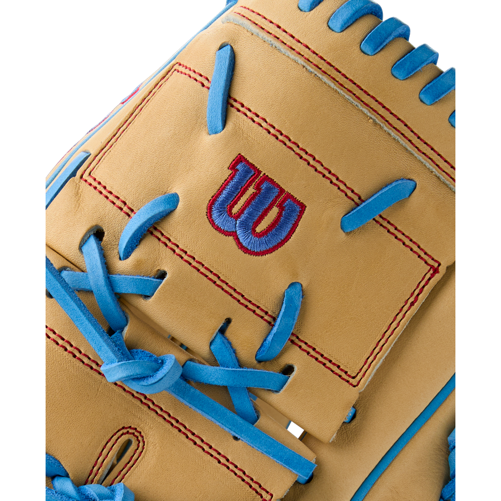 Close-up of the Wilson A2000 B125 12.5" Baseball Glove (Summer 2025), featuring tan Pro Stock leather, blue laces, red stitching, and a red and blue W logo on a rectangular patch. Model: WBW103220125.