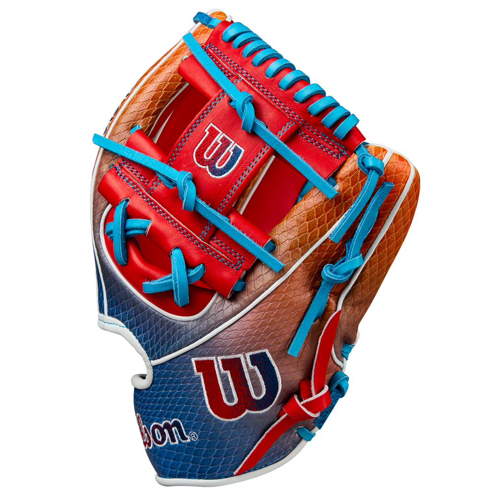 The Wilson A2K 1786SS 11.5" Baseball Glove (Summer 2025: WBW103290115) features a red, blue, orange, and brown design with blue laces, SuperSnakeSkin texture, and visible Wilson logos in red and white on the palm and wrist.