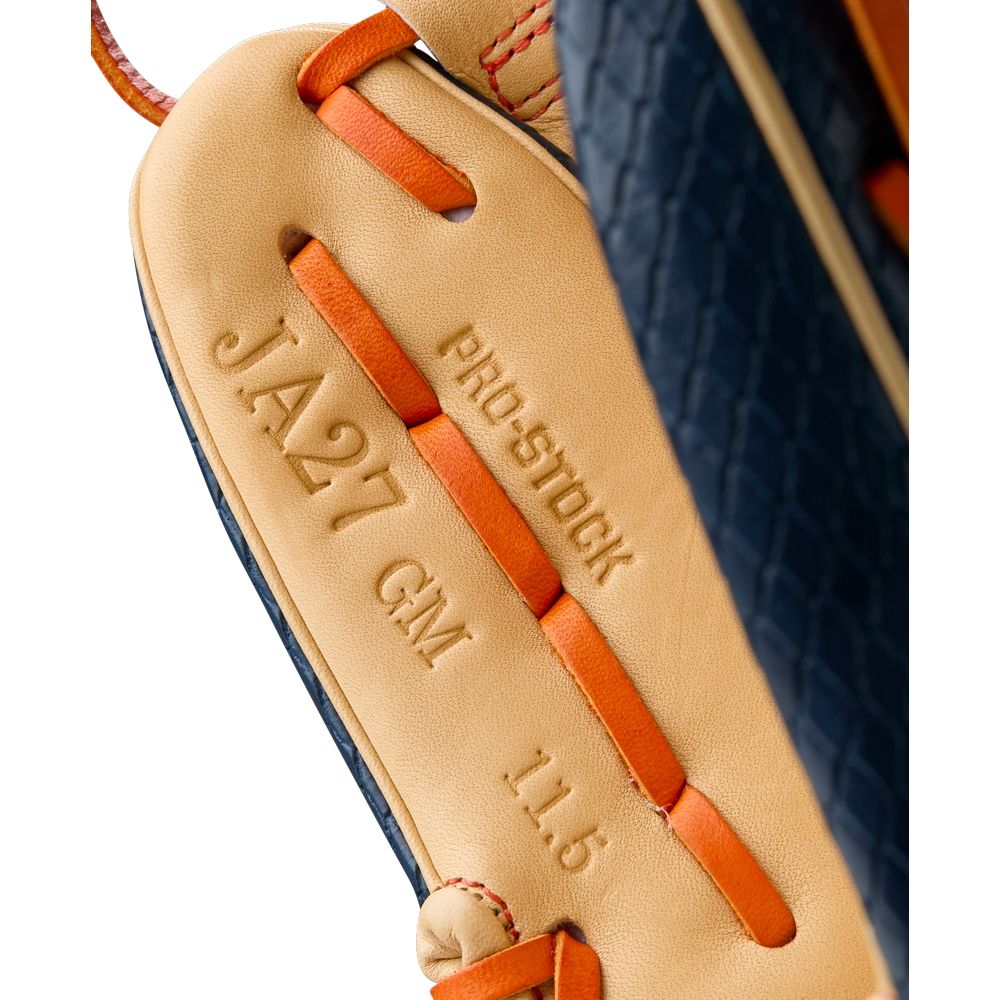 Close-up of the Wilson A2000 JA27 11.5" Jose Altuve GM Baseball Glove, featuring tan Pro Stock leather, orange lacing, and stamps reading JA27 GM, PRO-STOCK, and 11.5" (model WBW103295115).