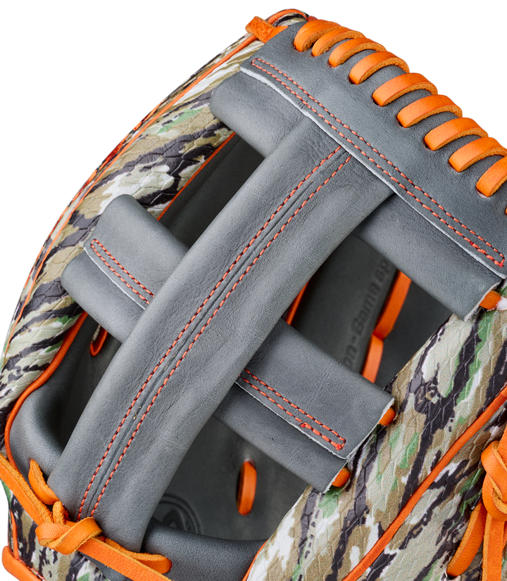Close-up of a Wilson A2000 GH2 11.75" Gunnar Henderson GM Baseball Glove (WBW1034511175) with camouflage-patterned leather, gray palm, and orange laces. The partially open glove reveals part of the interior.
