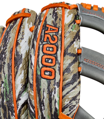 Close-up of the Wilson A2000 GH2 11.75" Gunnar Henderson GM Baseball Glove (WBW1034511175), featuring a camouflage pattern, orange stitching and trim, gray straps, and the A2000 GH2 GM marking embroidered in orange.