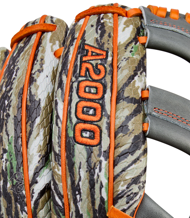 Close-up of the Wilson A2000 GH2 11.75" Gunnar Henderson GM Baseball Glove (WBW1034511175), featuring a camouflage pattern, orange stitching and trim, gray straps, and the A2000 GH2 GM marking embroidered in orange.