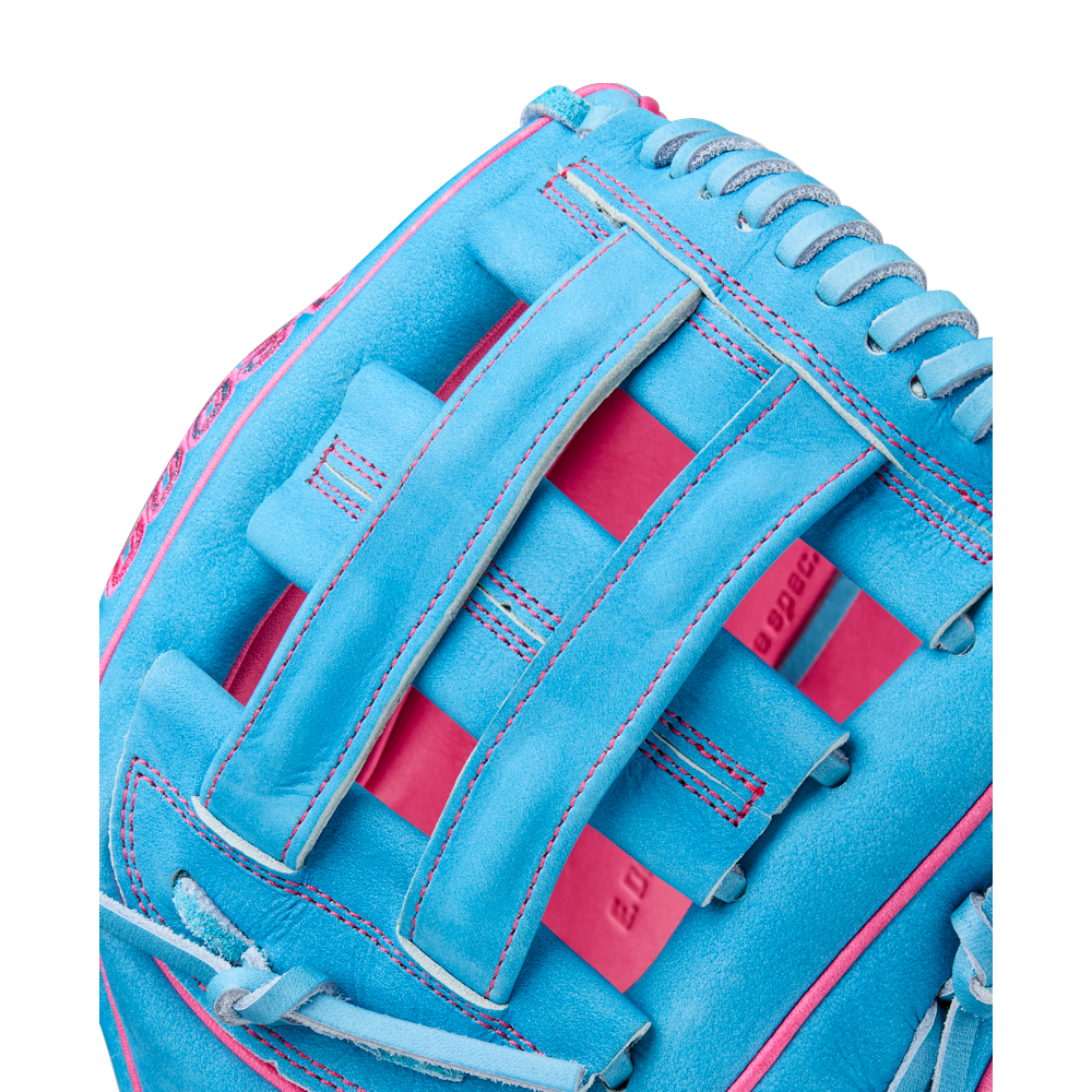 A close-up of the Wilson A2000 EDLC44 12" Elly De La Cruz Gameday Baseball Glove, FALL 2025 (WBW10345212), in bright blue with pink stitching and woven web design, showing detailed leather texture.
