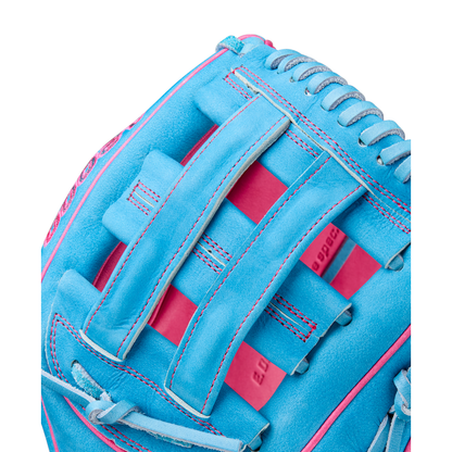 A close-up of the Wilson A2000 EDLC44 12" Elly De La Cruz Gameday Baseball Glove, FALL 2025 (WBW10345212), in bright blue with pink stitching and woven web design, showing detailed leather texture.