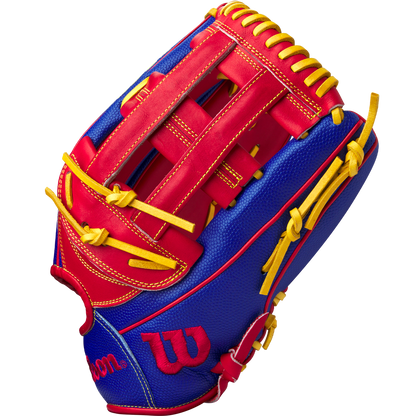 The Wilson A2000 1799SS 12.75" Pete Crow-Armstrong GM Baseball Glove (GOTM Jan 2025) features bold red and blue leather, yellow laces and stitching, plus a red W logo on the thumb—an eye-catching glove for any player.