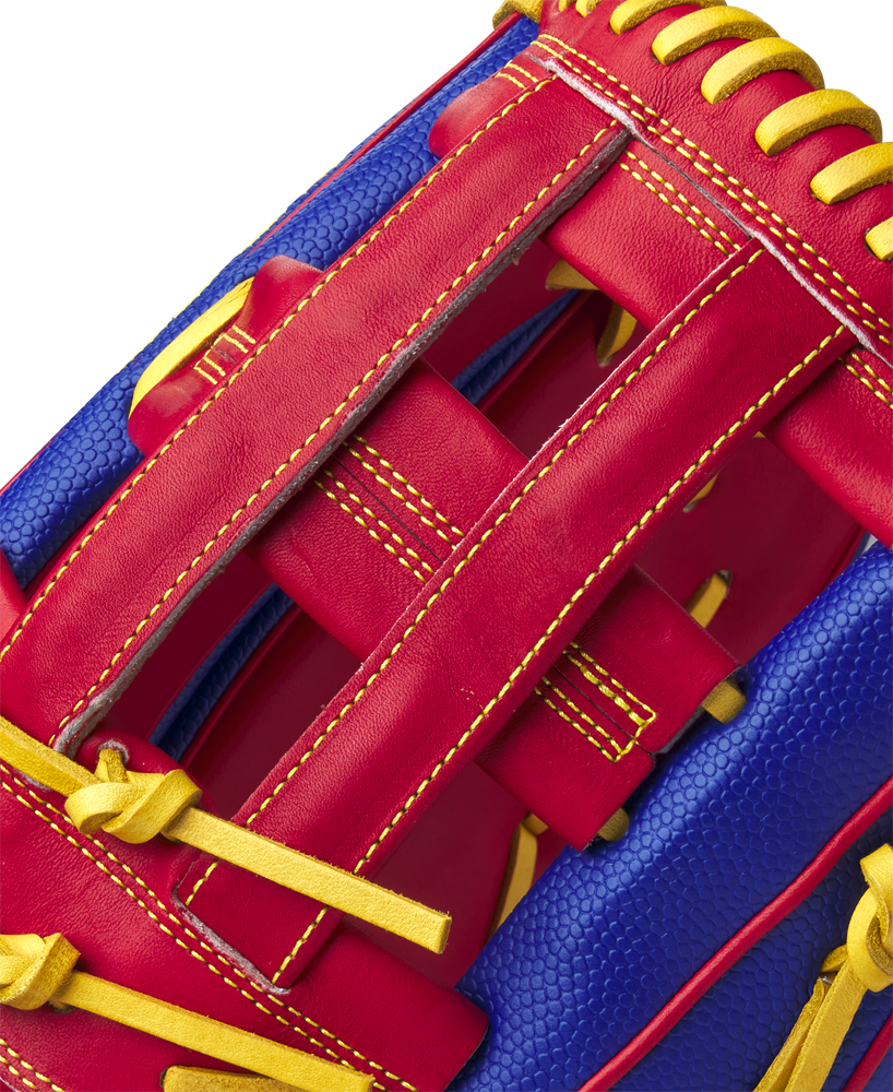 Close-up of the Wilson A2000 1799SS Pete Crow-Armstrong GM 12.75" Baseball Glove (GOTM Jan 2025), showing off bold red leather, yellow stitching, blue textured leather, and Wilson’s detailed craftsmanship.