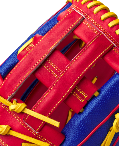 Close-up of the Wilson A2000 1799SS Pete Crow-Armstrong GM 12.75" Baseball Glove (GOTM Jan 2025), showing off bold red leather, yellow stitching, blue textured leather, and Wilson’s detailed craftsmanship.