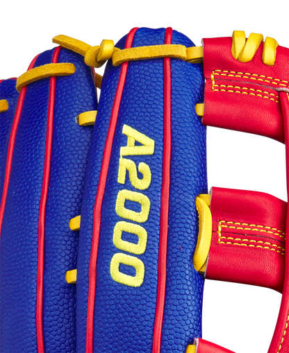 Close-up of a blue Wilson A2000 1799SS 12.75" Pete Crow-Armstrong GM Baseball Glove (GOTM January 2025) with red and yellow accents, yellow stitching, and "A2000 1799SS" embroidered in yellow on the glove's surface.