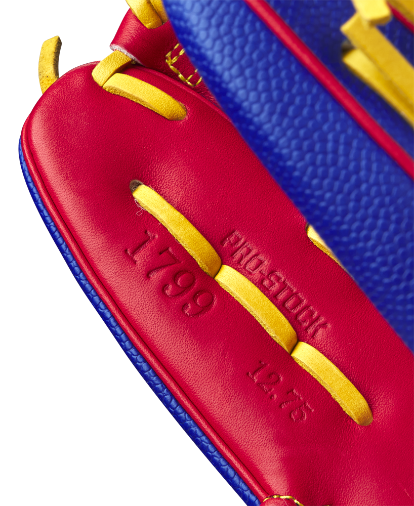 Close-up of the red leather interior and yellow laces of the Wilson A2000 1799SS 12.75" Pete Crow-Armstrong GM Baseball Glove (GOTM Jan 2025), featuring embossed 1799 and 12.75 with partially visible PRO STOCK text.
