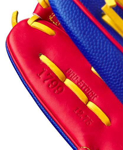 Close-up of the red leather interior and yellow laces of the Wilson A2000 1799SS 12.75" Pete Crow-Armstrong GM Baseball Glove (GOTM Jan 2025), featuring embossed 1799 and 12.75 with partially visible PRO STOCK text.