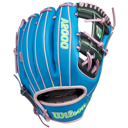 The Wilson A2000 1786SS 11.5" GOTM March 2025 glove (WBW103479115) features blue SuperSkin, pink lacing and trim, a black palm area, and green embroidered lettering. Shown on a white background. Brand: Wilson.