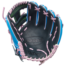 The Wilson A2000 1786SS 11.5" Baseball Glove (GOTM March 2025, WBW103479115) features durable Pro Stock leather, a black palm, blue shell, pink laces, green stitching accents, and an embossed Wilson logo inside.
