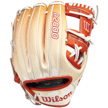 The Wilson A2000 1975SS 11.75" Baseball Glove (GOTM June 2025: WBW1034811175) by Wilson features tan and white Pro Stock leather, red accents, white lacing, and embroidered thumb branding, shown from the top side.