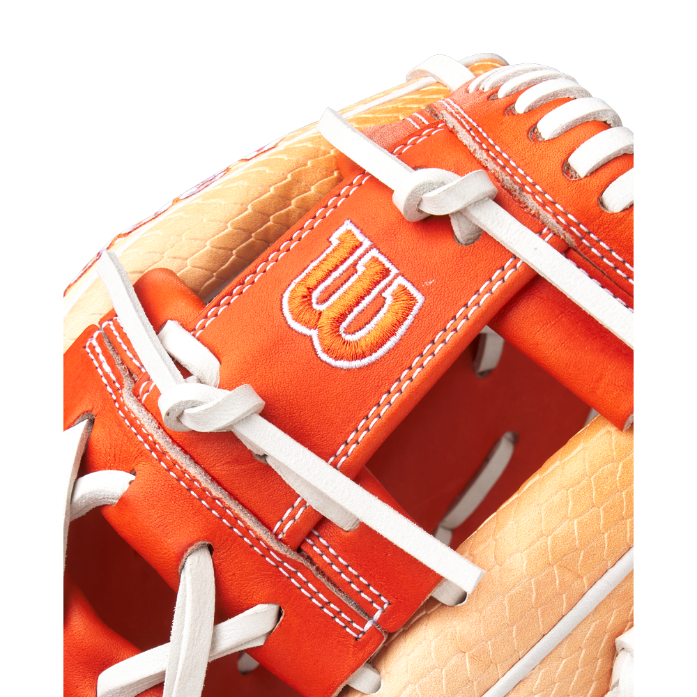 Close-up of the Wilson A2000 1975SS 11.75" Baseball Glove (GOTM June 2025, WBW1034811175) in orange and tan Pro Stock leather, featuring white stitching, laces, and the signature embroidered white W logo.