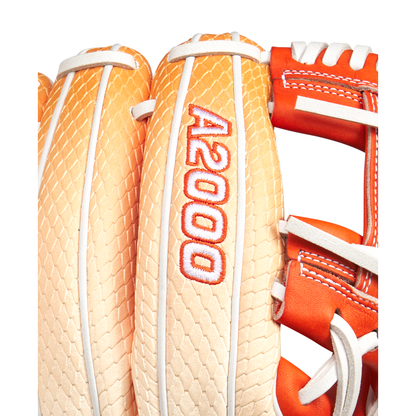 Close-up of a tan and orange Wilson A2000 1975SS 11.75" Baseball Glove (GOTM June 2025) featuring Pro Stock leather with white stitching, red A2000 embroidery, and a textured, scale-like pattern on the back.