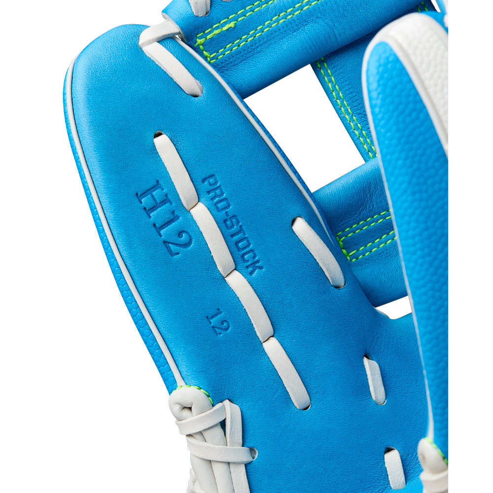 Close-up of a Wilson A2000 H12SS 12" Fastpitch Glove (WBW10348612) by Wilson, showing blue leather with white laces, "H12," "PRO STOCK," and "12" embossed on the palm, plus green stitching along the edges.