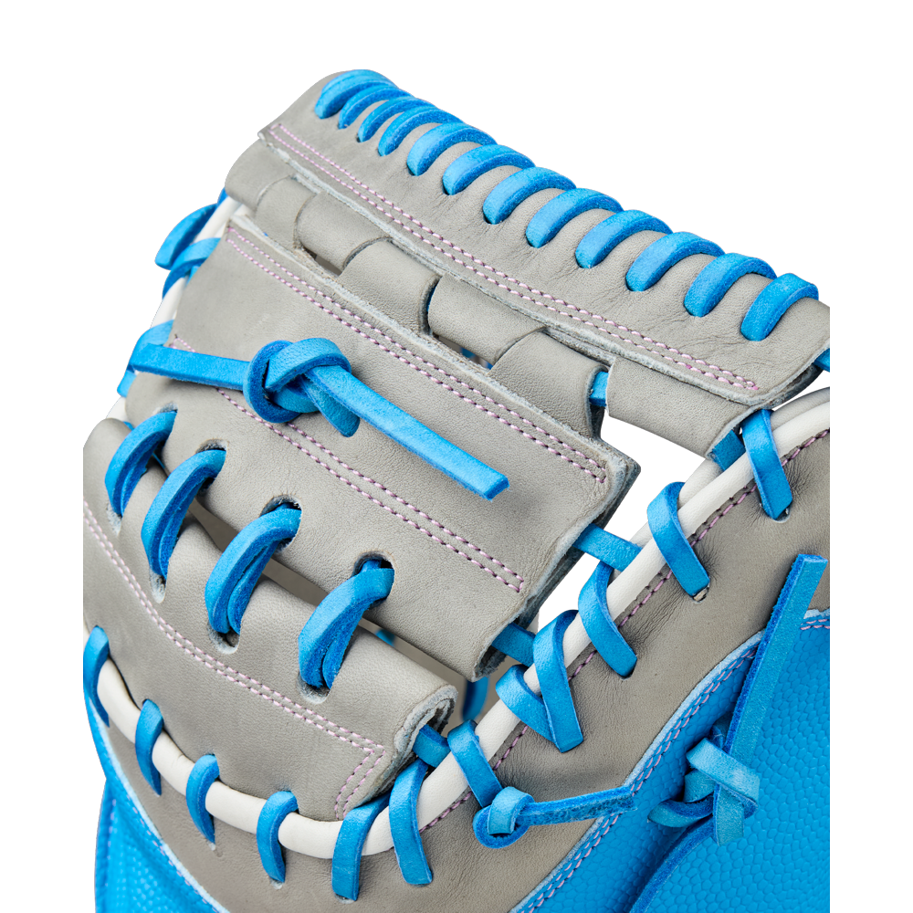 Close-up of the Wilson A2000 FPCM23 34" Fastpitch Catcher's Mitt (WBW10349134), highlighting gray leather with blue and white laces, and detailed stitching, set against a white background.