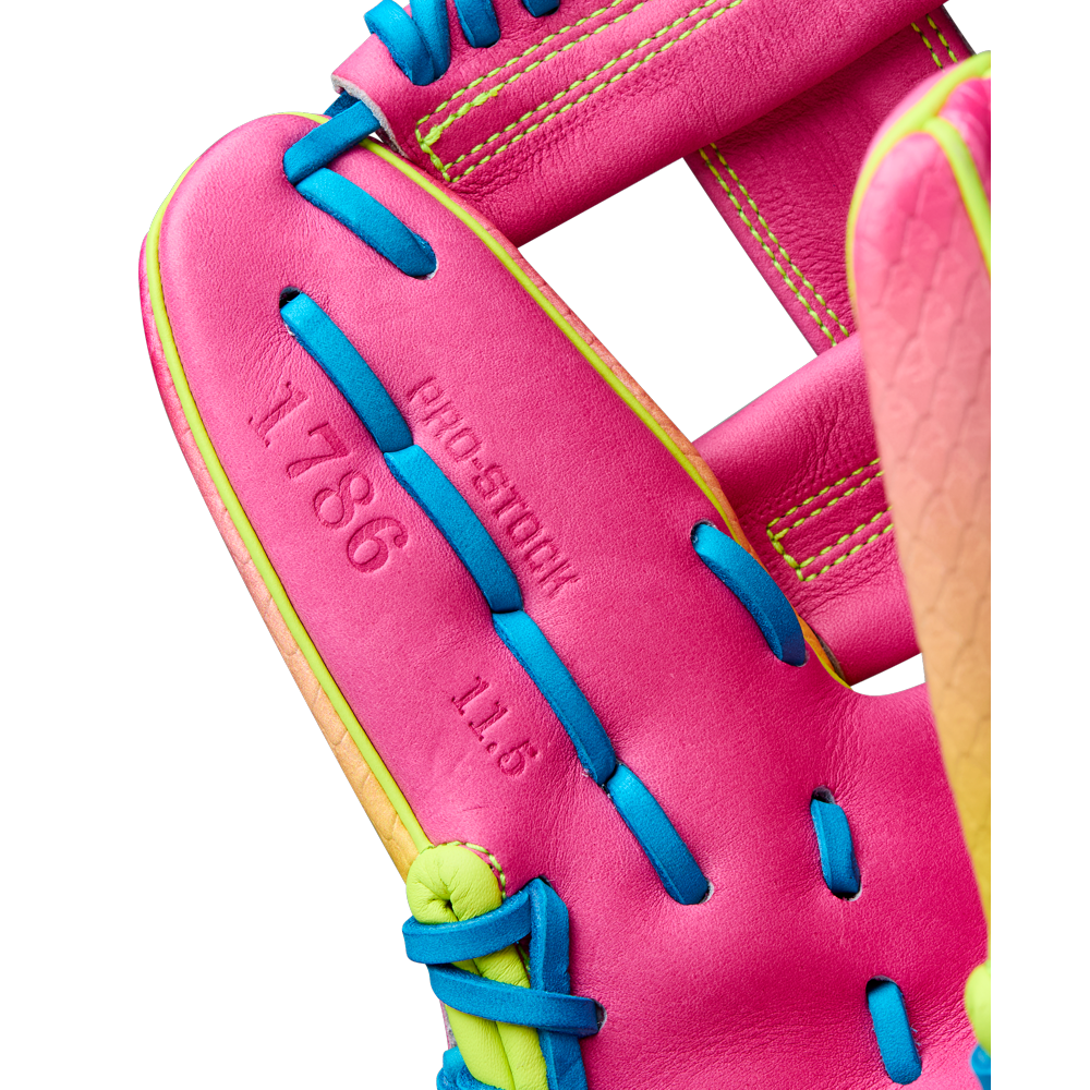 Close-up of the Wilson A2000 1786SS 11.5" Baseball Glove (WBW103492115), featuring bright pink SuperSkin leather with blue and yellow laces, PRO STOCK stamp, and a vibrant look perfect for infielders in Fall 2025.