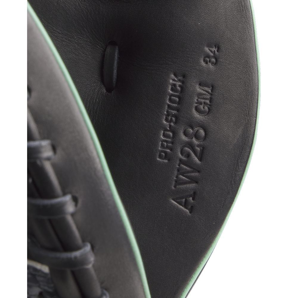 Close-up of black leather and light green trim on the Wilson A2000 AW28 34" Austin Wells Gameday Catcher's Mitt, FALL 2025 (WBW10349434), showing embossed "PRO-STOCK," "AW28 CM 34," and other markings inside the mitt.