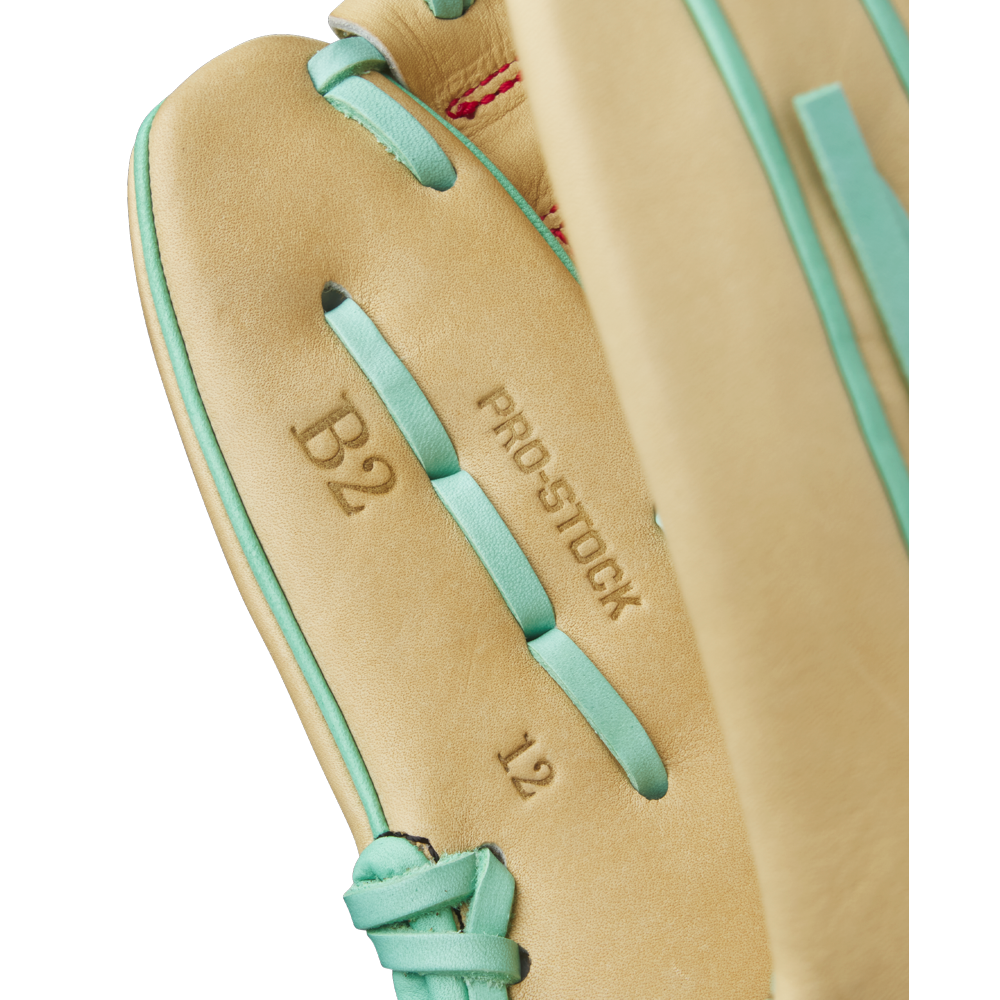 Close-up of the Wilson A2000 B12 12" Baseball Glove (WBW10349812) by Wilson, featuring a tan interior with aqua laces and markings “B2,” “PRO-STOCK,” and “12.” Made with premium Pro Stock leather for pitchers seeking top performance.