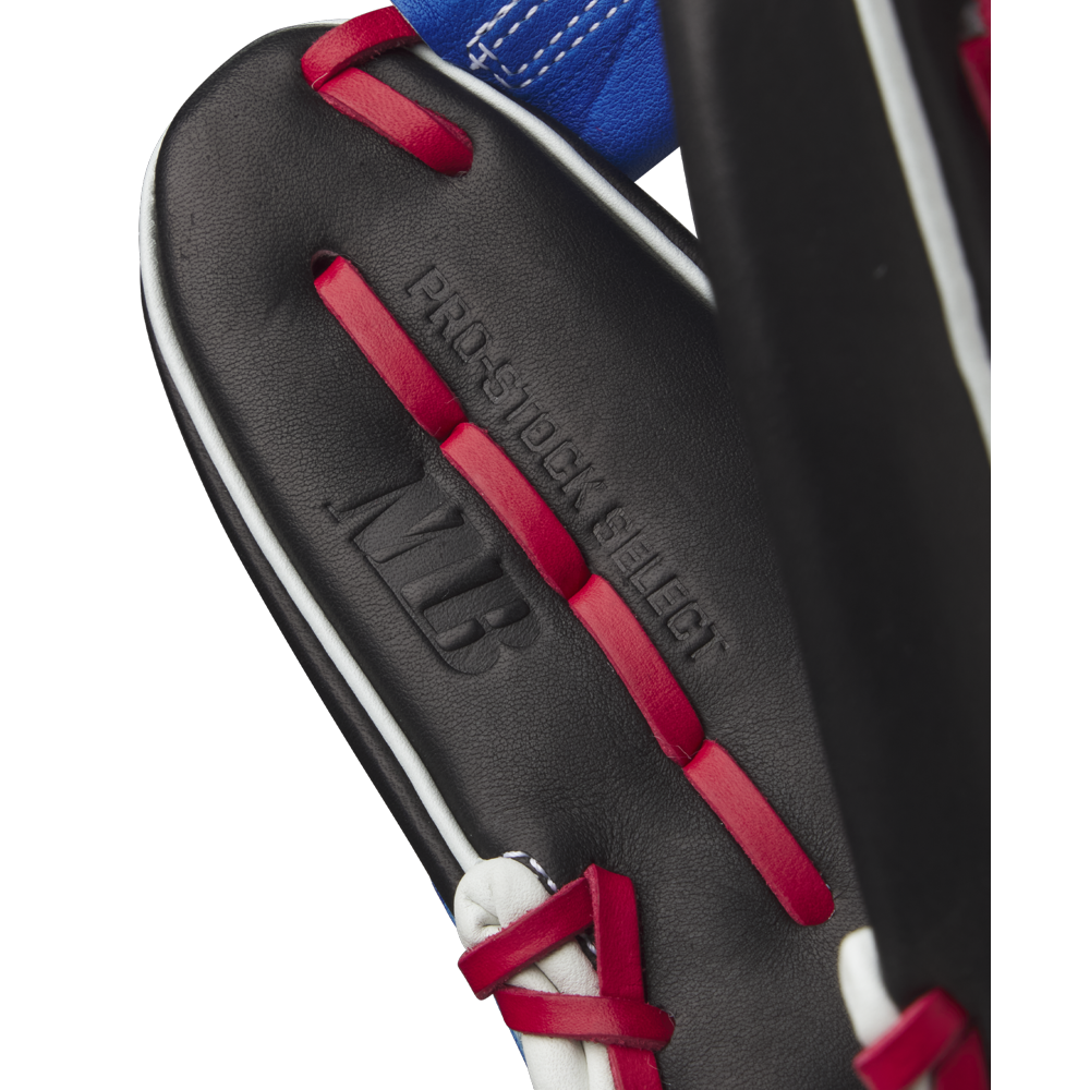 Close-up of a Wilson A2K MB1175 11.75" Mookie Betts Gameday Glove in black with red laces, white trim, and blue accents, featuring embossed PRO STOCK SELECT and MLB text on premium Pro Stock Select leather.
