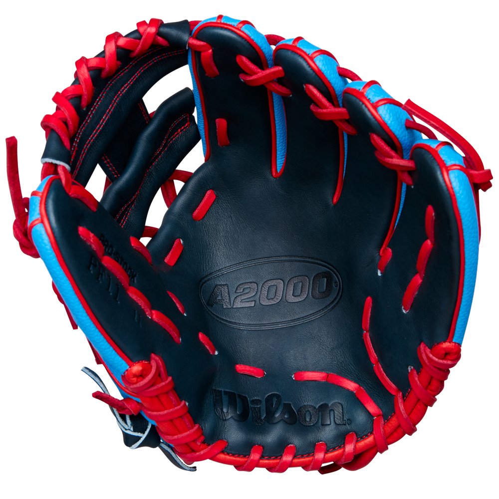 The Wilson A2000 PF11SS 11" Baseball Glove by Wilson, shown open with the palm up against a white background, features blue and black Pro Stock leather, red laces, and Pedroia Fit Technology for infield use.