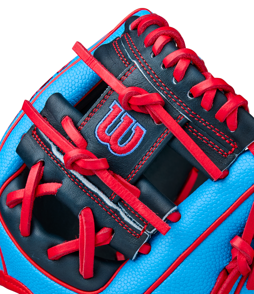 Close-up of a blue and black Wilson A2000 PF11SS 11" Baseball Glove (WBW10394011) with red laces and stitching, featuring Pro Stock leather and a red W logo on a black patch.