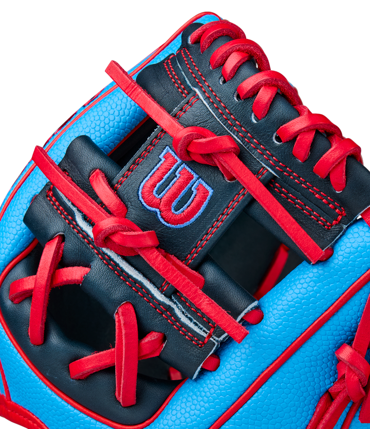 Close-up of a blue and black Wilson A2000 PF11SS 11" Baseball Glove (WBW10394011) with red laces and stitching, featuring Pro Stock leather and a red W logo on a black patch.