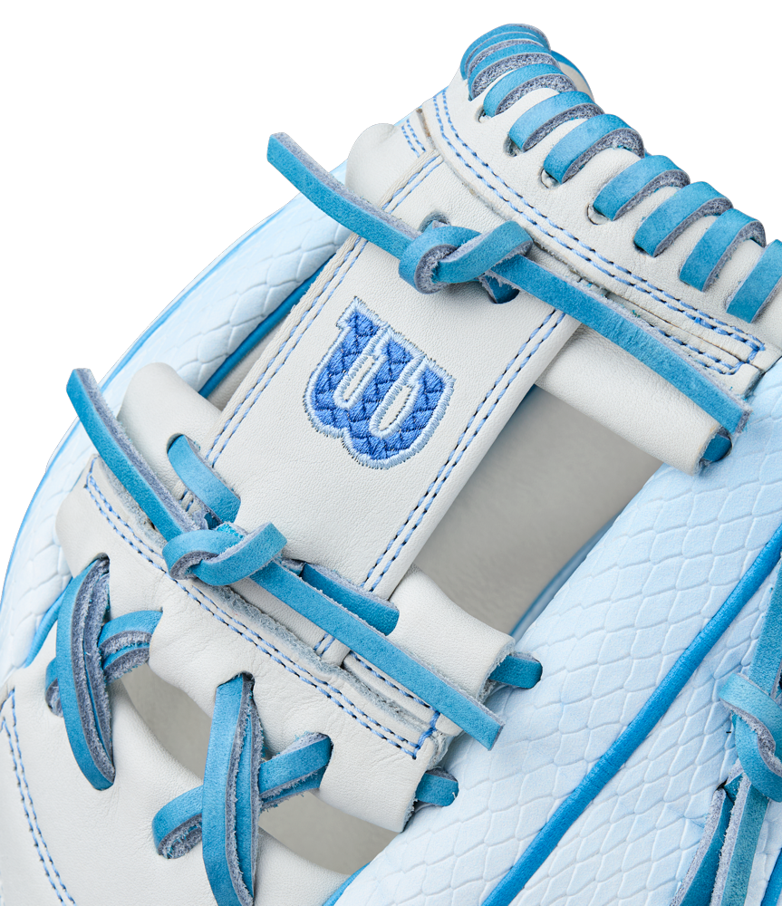 Close-up of the Wilson A2000 H12SS 12" Fastpitch Glove (WBW10394612) in white, with light blue laces and trim, a textured pattern, and an embroidered blue W logo on a Pro Stock leather patch.