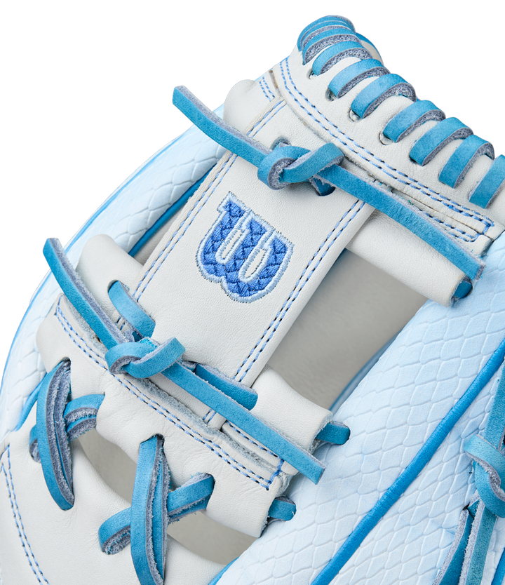 Close-up of the Wilson A2000 H12SS 12" Fastpitch Glove (WBW10394612) in white, with light blue laces and trim, a textured pattern, and an embroidered blue W logo on a Pro Stock leather patch.