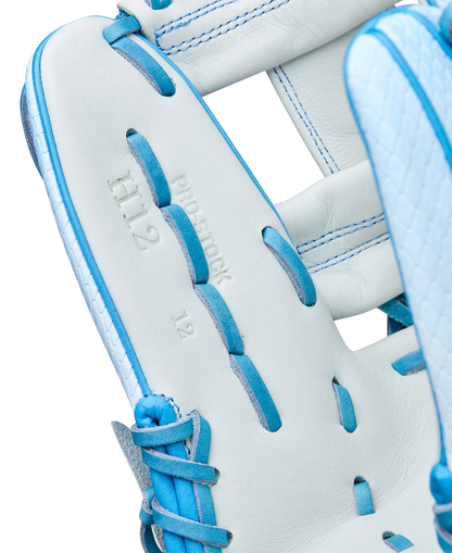 Close-up of the Wilson A2000 H12SS 12" Fastpitch Glove (WBW10394612) in white with blue laces, showcasing Pro Stock leather, embossed “H12,” “PRO STOCK,” and “12,” and Wilson’s expert craftsmanship.