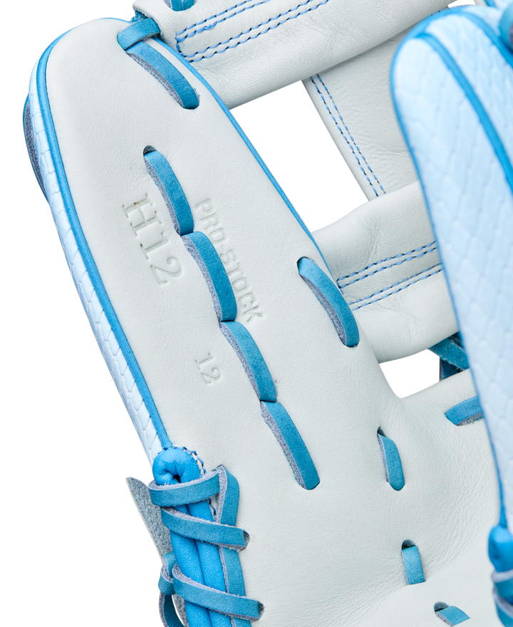 Close-up of the Wilson A2000 H12SS 12" Fastpitch Glove (WBW10394612) in white with blue laces, showcasing Pro Stock leather, embossed “H12,” “PRO STOCK,” and “12,” and Wilson’s expert craftsmanship.