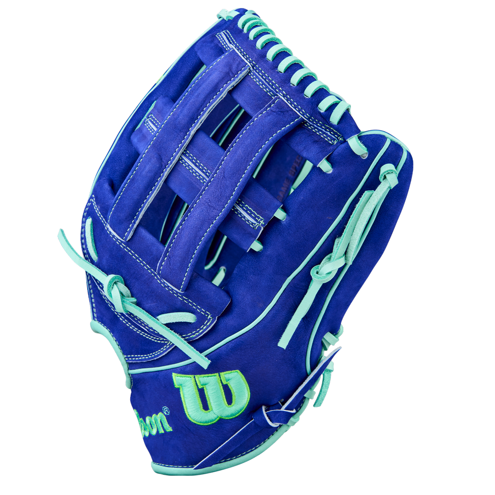 The Wilson A2K JS22 12.75" Juan Soto GM Baseball Glove features royal blue Pro Stock Select leather, light teal laces and accents, plus a green Wilson logo outlined in teal on the wrist.