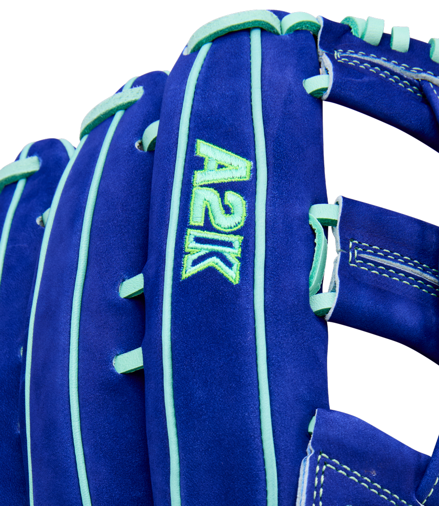 Close-up of the Wilson A2K JS22 12.75" Juan Soto GM Baseball Glove, crafted with Pro Stock Select leather in blue and teal, featuring teal stitching and laces plus green "A2K" embroidery on the side.