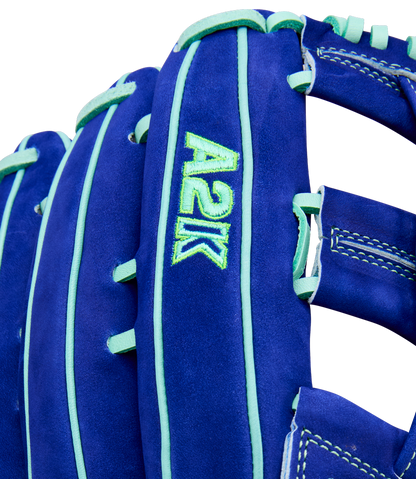 Close-up of the Wilson A2K JS22 12.75" Juan Soto GM Baseball Glove, crafted with Pro Stock Select leather in blue and teal, featuring teal stitching and laces plus green "A2K" embroidery on the side.