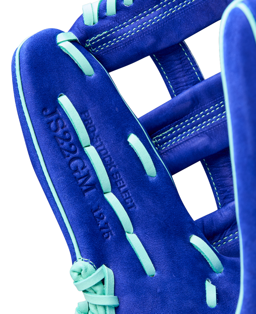 Close-up of a Wilson A2K JS22 12.75" Juan Soto GM Baseball Glove in blue with light blue laces and embossed details such as JS22GGM, the model name, and size, visible on the Pro Stock Select leather.