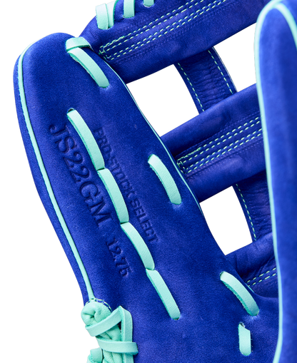 Close-up of a Wilson A2K JS22 12.75" Juan Soto GM Baseball Glove in blue with light blue laces and embossed details such as JS22GGM, the model name, and size, visible on the Pro Stock Select leather.