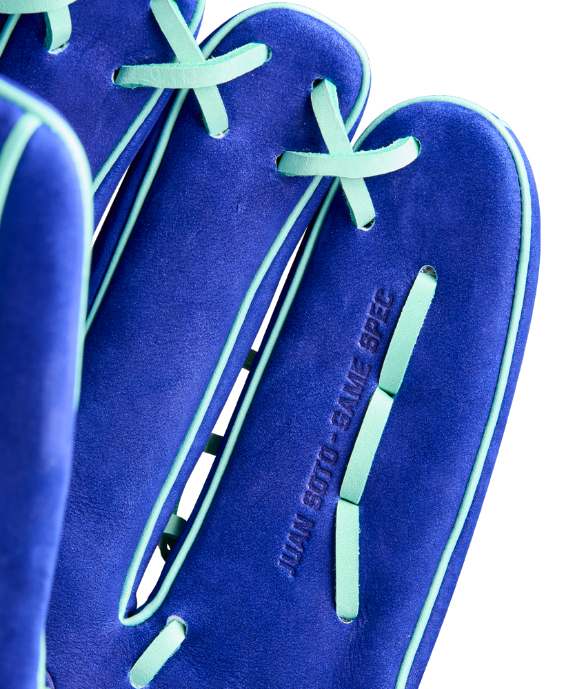 Close-up of the Wilson A2K JS22 12.75" Juan Soto GM Baseball Glove by Wilson, featuring blue Pro Stock Select leather with light green laces and trim, and "JUAN SOTO - GAME SPEC" embossed on the surface.