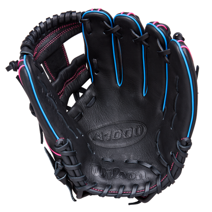 The Wilson A1000 DP15 11.5" Baseball Glove (WBW103956115) features a black design with pink stitching, blue trim, visible laces, and palm branding. Made from full grain leather for lasting performance.